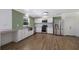 Bright kitchen featuring stainless steel appliances, white cabinets, and an adjacent dining area at 10712 Forest Run Dr, Bradenton, FL 34211