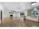 Bright living room featuring wood floors, fireplace, and open access to the backyard at 10712 Forest Run Dr, Bradenton, FL 34211