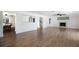 Spacious living room with wood flooring, fireplace, and entry to the dining area at 10712 Forest Run Dr, Bradenton, FL 34211