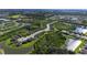 An aerial view of a community boasting well-maintained lawns, peaceful ponds, and winding walking trails at 10806 52Nd E Ct, Parrish, FL 34219