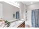 Bright bathroom features granite counter, large mirror, vanity, shower and bath with curtain at 10806 52Nd E Ct, Parrish, FL 34219