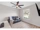 Cozy bedroom offers a black leather sofa, ceiling fan, and lots of natural light from the window at 10806 52Nd E Ct, Parrish, FL 34219
