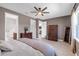 Spacious bedroom showing wood floors, ceiling fan, Primary bath entrance, and neutral colors at 10806 52Nd E Ct, Parrish, FL 34219