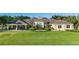 Attractive clubhouse set on manicured green lawn lined with palm trees and lush landscaping at 10806 52Nd E Ct, Parrish, FL 34219