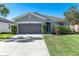 Charming single-story home with a well-manicured lawn and attached two-car garage at 10806 52Nd E Ct, Parrish, FL 34219