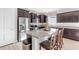Bright kitchen features stainless steel appliances, granite counters, large island, and ample dark wood cabinetry at 10806 52Nd E Ct, Parrish, FL 34219