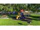 Community playground surrounded by lush trees and picnic tables for a fun, Gathering-friendly outdoor experience at 10806 52Nd E Ct, Parrish, FL 34219