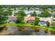 Aerial view of the home with a screened-in pool, nestled among lush greenery and overlooking the lake at 11215 Rivers Bluff Cir, Lakewood Ranch, FL 34202