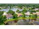 Aerial view of the community home featuring a screened pool, lush greenery, and a serene lake view at 11215 Rivers Bluff Cir, Lakewood Ranch, FL 34202