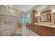 Elegant bathroom featuring double sinks, a walk-in shower and stylish tiled floors at 11215 Rivers Bluff Cir, Lakewood Ranch, FL 34202