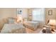 Bright bedroom with two twin beds and decor to enhance the beach living style at 11215 Rivers Bluff Cir, Lakewood Ranch, FL 34202