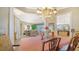 Elegant dining room with chandelier and view into the living room and kitchen at 11215 Rivers Bluff Cir, Lakewood Ranch, FL 34202