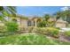 Beautifully landscaped front yard featuring lush greenery and a charming home exterior at 11215 Rivers Bluff Cir, Lakewood Ranch, FL 34202