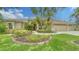 Well-maintained home with a manicured lawn and vibrant landscaping at 11215 Rivers Bluff Cir, Lakewood Ranch, FL 34202