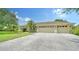 Spacious home featuring a three-car garage with a wide driveway and lush landscaping at 11215 Rivers Bluff Cir, Lakewood Ranch, FL 34202