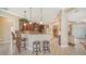 Inviting kitchen with dark wood cabinets, granite countertops, and stylish pendant lighting at 11215 Rivers Bluff Cir, Lakewood Ranch, FL 34202