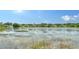 Scenic lake view with shoreline and reflections of the sky and surrounding community homes at 11215 Rivers Bluff Cir, Lakewood Ranch, FL 34202