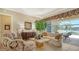 Cozy living room opens to a screened lanai with views of the pool and lake at 11215 Rivers Bluff Cir, Lakewood Ranch, FL 34202