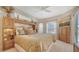 Cozy main bedroom with plush bedding, custom built-ins, and plenty of natural light at 11215 Rivers Bluff Cir, Lakewood Ranch, FL 34202