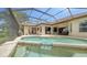 A screened pool and spa area with outdoor seating adjacent to the home, with open access to the backyard at 11215 Rivers Bluff Cir, Lakewood Ranch, FL 34202
