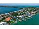 Stunning aerial view of waterfront homes, with lush landscaping, private docks, and sparkling blue waters at 1435 Westway Dr, Sarasota, FL 34236