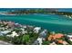 Breathtaking aerial shot of waterfront homes on the coast with clear turquoise water at 1435 Westway Dr, Sarasota, FL 34236
