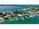 Beautiful waterfront houses with private docks and pools line the turquoise coast in this scenic aerial view at 1435 Westway Dr, Sarasota, FL 34236