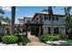 Stately two-story home with a pergola, lush greenery, and a brick pathway at 1435 Westway Dr, Sarasota, FL 34236