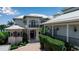 Elegant two-story home featuring wrought iron balconies and a brick driveway at 1435 Westway Dr, Sarasota, FL 34236