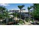 Elegant two-story home featuring lush landscaping and a charming pergola-covered entrance at 1435 Westway Dr, Sarasota, FL 34236