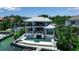 Luxurious waterfront home with a sleek pool, covered outdoor seating, and lush tropical landscaping at 1435 Westway Dr, Sarasota, FL 34236