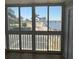 Enclosed balcony offering waterfront view with palm trees and bridge at 150 Harborside Ave # 221, Punta Gorda, FL 33950