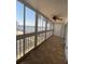 Enclosed tiled balcony overlooking a waterfront with palm trees and a bridge at 150 Harborside Ave # 221, Punta Gorda, FL 33950