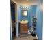 Cozy bathroom featuring vanity with cabinet storage and blue walls at 150 Harborside Ave # 221, Punta Gorda, FL 33950
