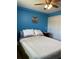 Blue bedroom featuring a ceiling fan, neutral bedding, and a double door closet at 150 Harborside Ave # 221, Punta Gorda, FL 33950