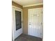 Exterior doorway featuring labeled doors for both the office and the workshop at 150 Harborside Ave # 221, Punta Gorda, FL 33950