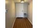 Hallway featuring hard wood floors and white front door at 150 Harborside Ave # 221, Punta Gorda, FL 33950