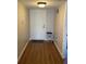 Hallway featuring hard wood floors and white front door at 150 Harborside Ave # 221, Punta Gorda, FL 33950