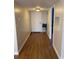 Inviting hallway with wood-look flooring, leading to various rooms at 150 Harborside Ave # 221, Punta Gorda, FL 33950