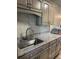 Stylish kitchen featuring granite countertops, a stainless steel sink, and elegant cabinetry at 150 Harborside Ave # 221, Punta Gorda, FL 33950