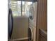 A practical laundry area with stacked washer and dryer next to a window at 150 Harborside Ave # 221, Punta Gorda, FL 33950
