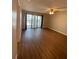 Bright living room featuring wood floors and sliding glass doors to a balcony at 150 Harborside Ave # 221, Punta Gorda, FL 33950