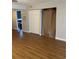 Open living room featuring wood-look flooring and ample closet space at 150 Harborside Ave # 221, Punta Gorda, FL 33950