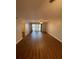 Spacious living room with wood floors, ceiling fan, and glass doors to the outdoors at 150 Harborside Ave # 221, Punta Gorda, FL 33950