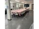 Meeting room setup with tables, chairs, and speckled flooring at 150 Harborside Ave # 221, Punta Gorda, FL 33950