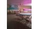 Inviting patio area with tables, chairs, and a mural featuring palm trees and a beach scene at 150 Harborside Ave # 221, Punta Gorda, FL 33950