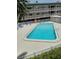 A refreshing community pool with lounge chairs and lush landscaping in a well-maintained complex at 150 Harborside Ave # 221, Punta Gorda, FL 33950