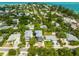 Captivating aerial view showcasing Gulf Coast neighborhood homes with tropical landscape at 159 Crescent Dr, Anna Maria, FL 34216