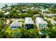 Scenic aerial view of Gulf Coast homes, showcasing a pool and lush tropical landscaping at 159 Crescent Dr, Anna Maria, FL 34216