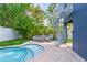 Tropical backyard featuring a spiral staircase, a cozy patio set, a manicured lawn, and a sparkling pool at 159 Crescent Dr, Anna Maria, FL 34216